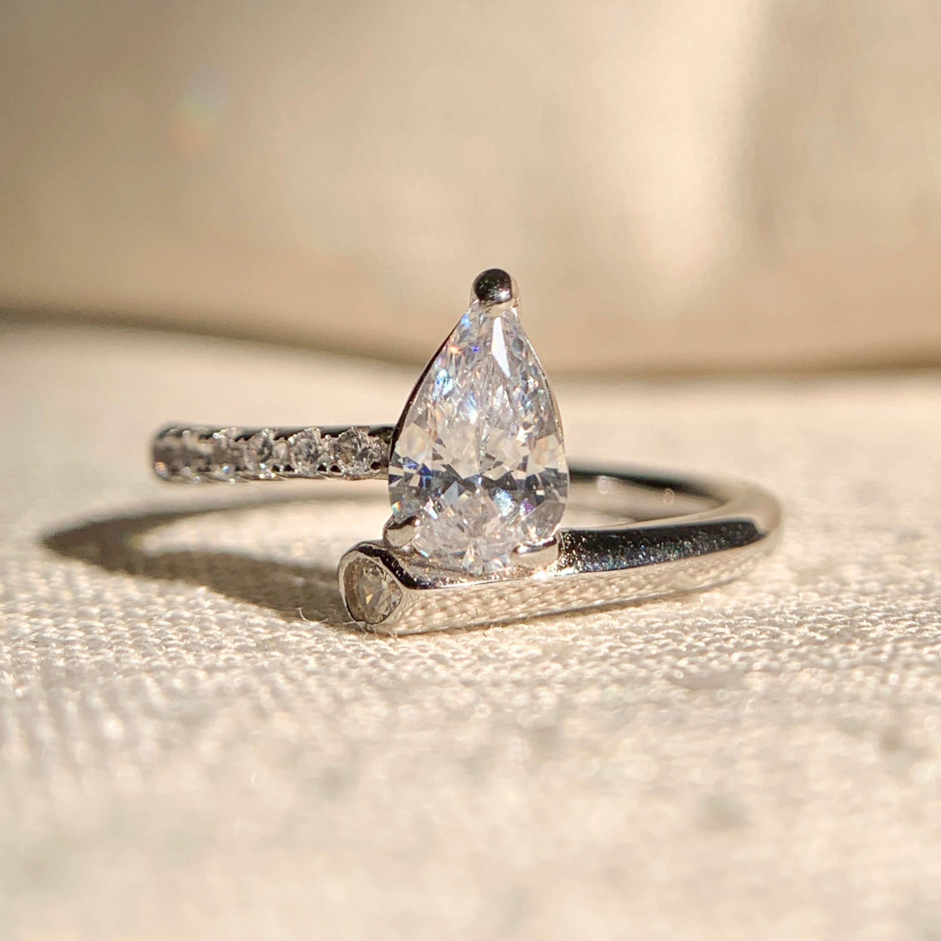 "Pear shaped solitaire engagement ring in white gold with sparkling diamond"